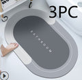Quick-dry absorbent bath mat on bathroom floor