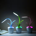 Modern plant-shaped LED desk lamp glowing warm