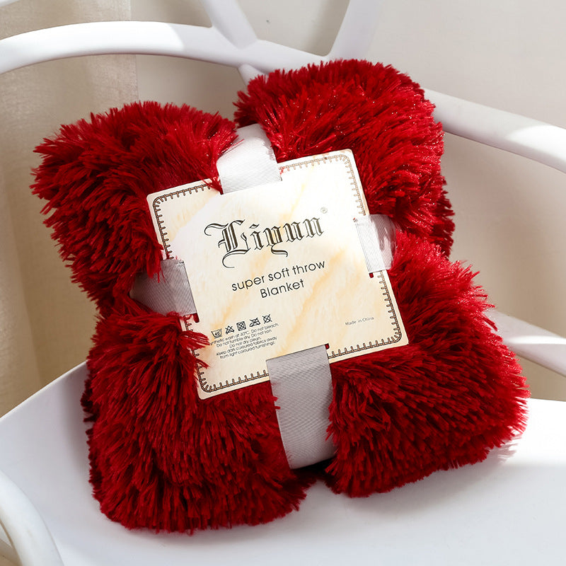 Super-soft coral fleece blanket on sofa